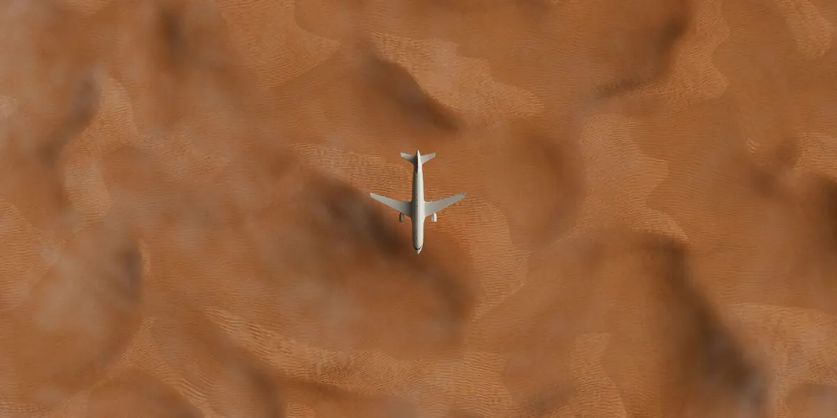 Jet flying over golden desert dunes