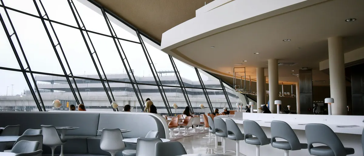Airport lounge with tall windows looking out over the apron