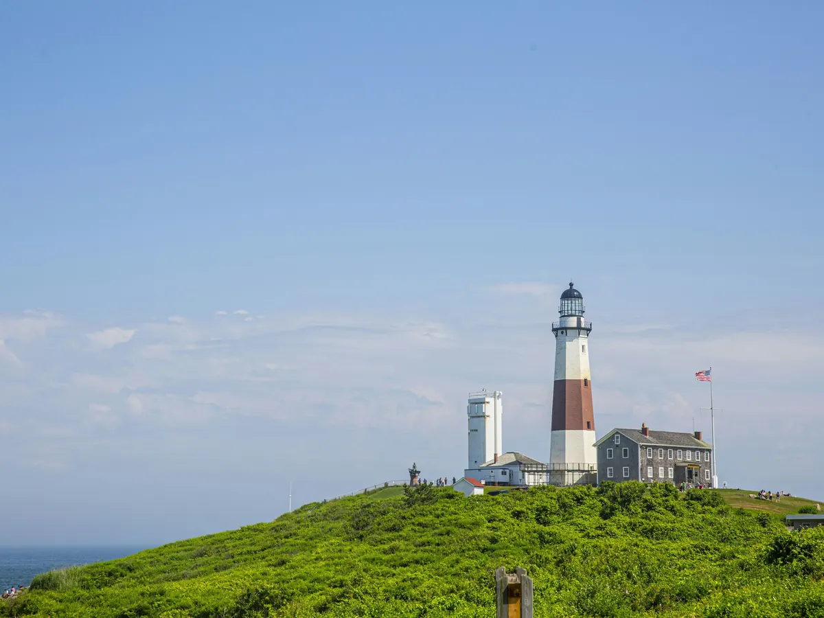 Montauk Point lighthouse on a green bluff above the ocean